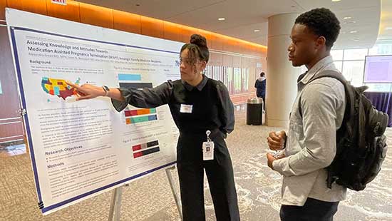 Attendees look at Global Health Education Day posters